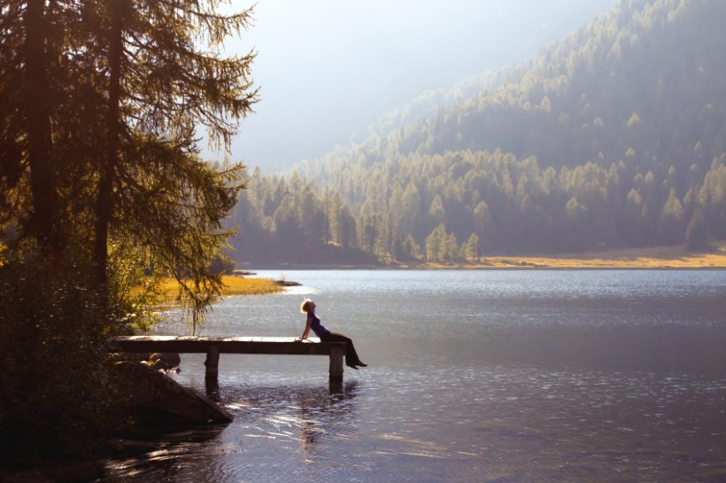 young woman enjoy the nature on the mountain lake